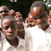students in white school uniform shirts eagerly posing for picture