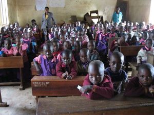 classroom packed full of African children in uniforms