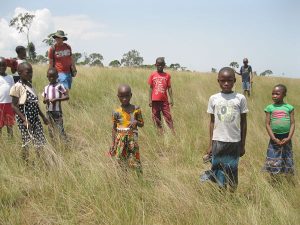 African children on a grassy hillside