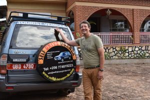 Our builder (and driver) standing next to a Land Cruiser labeled "Tourist Vehicle"