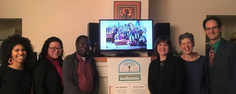 board members and donors gathered around display of mission statement