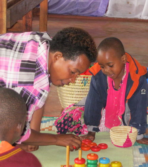 adult and child working together on mat on the floor