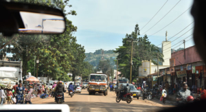 view of dusty busy town street from inside a vehicle