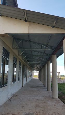 long outdoor corridor with classroom windows on one side and columns on other side