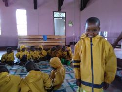 kids in bright yellow raincoats with hoods