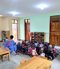 brightly lit classroom with children and teacher