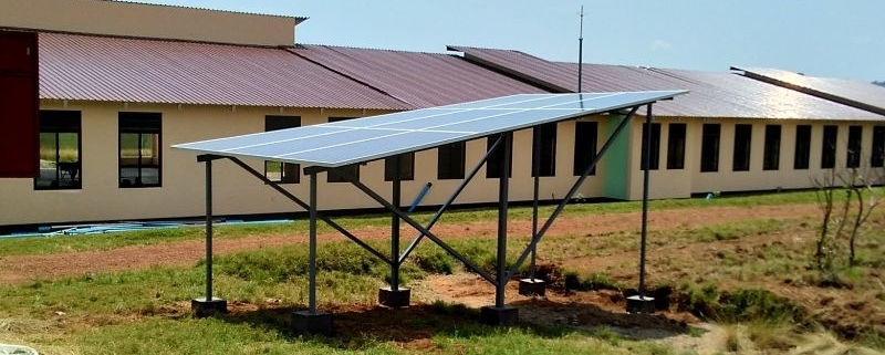 solar panels on stucture with school building behind