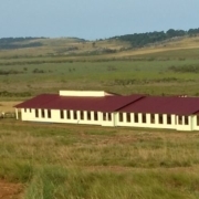 Long school building in grassy field