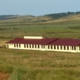 Long school building in grassy field