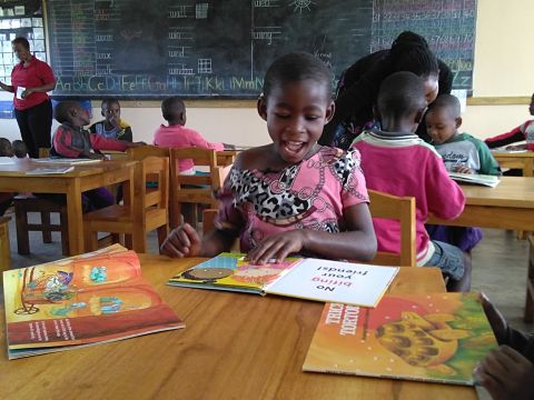 Children at tables reading books
