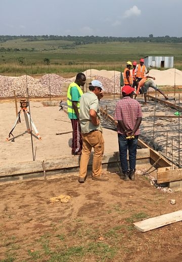construction site with foundation, rebar, workers