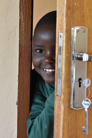 smiling girl peeking through door