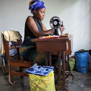 woman working at a treadle sewing maching
