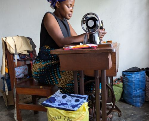 woman working at a treadle sewing maching