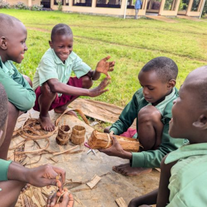 children making pots from dried banana plants