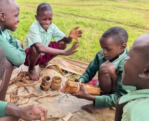 children making pots from dried banana plants