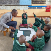 Teacher with 6 kids reading in a group