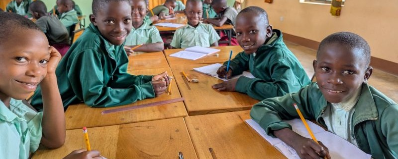 group of students at desks with pencils and notebooks